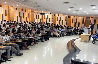 Full auditorium at a community talk